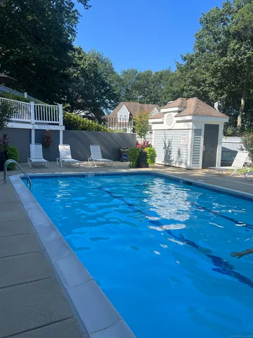 a view of swimming pool with sitting area