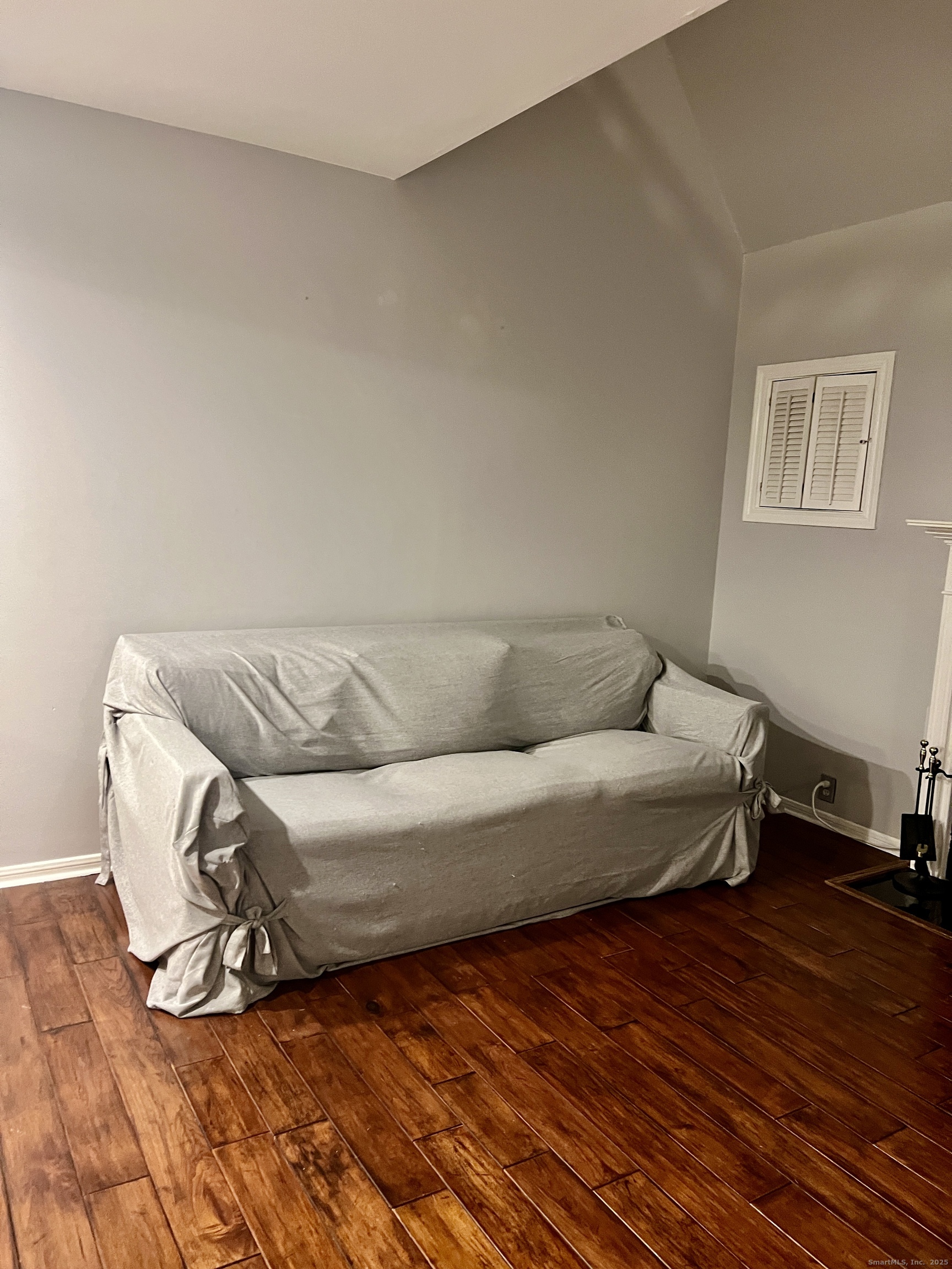 523 Old Pond Lane, Unit 523 Norwich, CT 06360 - Photo 3 of 25 a living room with a bed and a wooden floor
