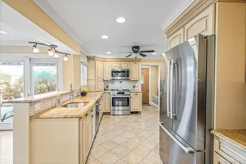 a kitchen with stainless steel appliances a refrigerator sink and stove