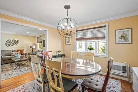 a view of a dining room with furniture wooden floor and chandelier