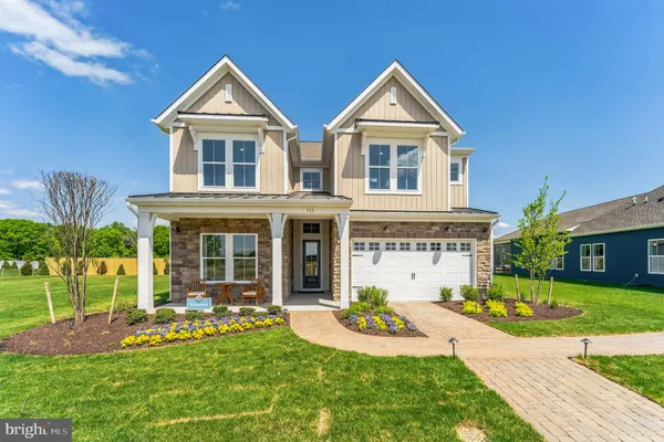a front view of a house with garden and porch