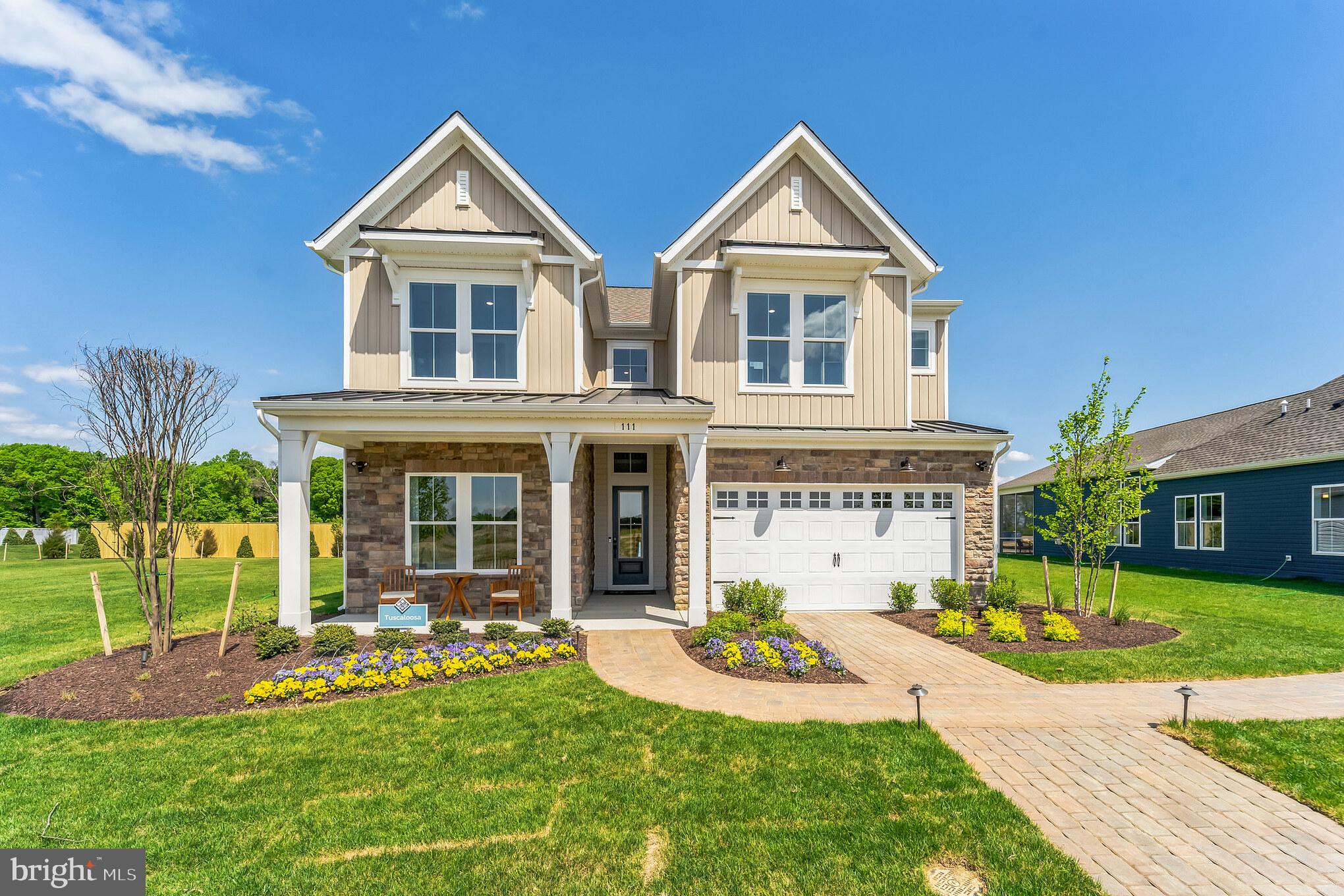 a front view of a house with garden and porch