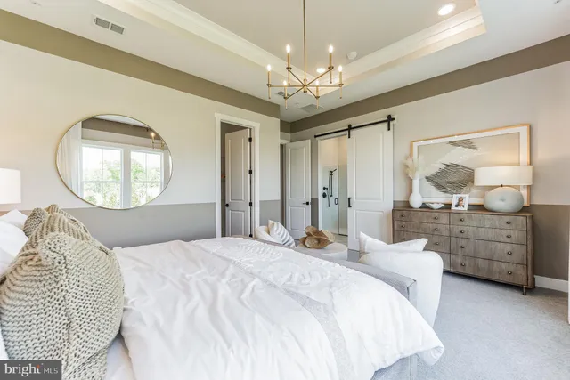 a bedroom with a large bed and a mirror