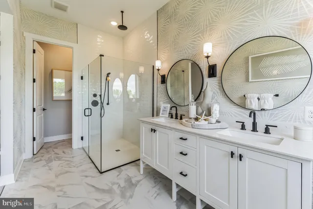 a bathroom with a double vanity sink mirror and shower