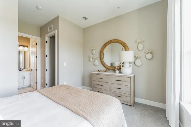 a bedroom with a bed and a dresser