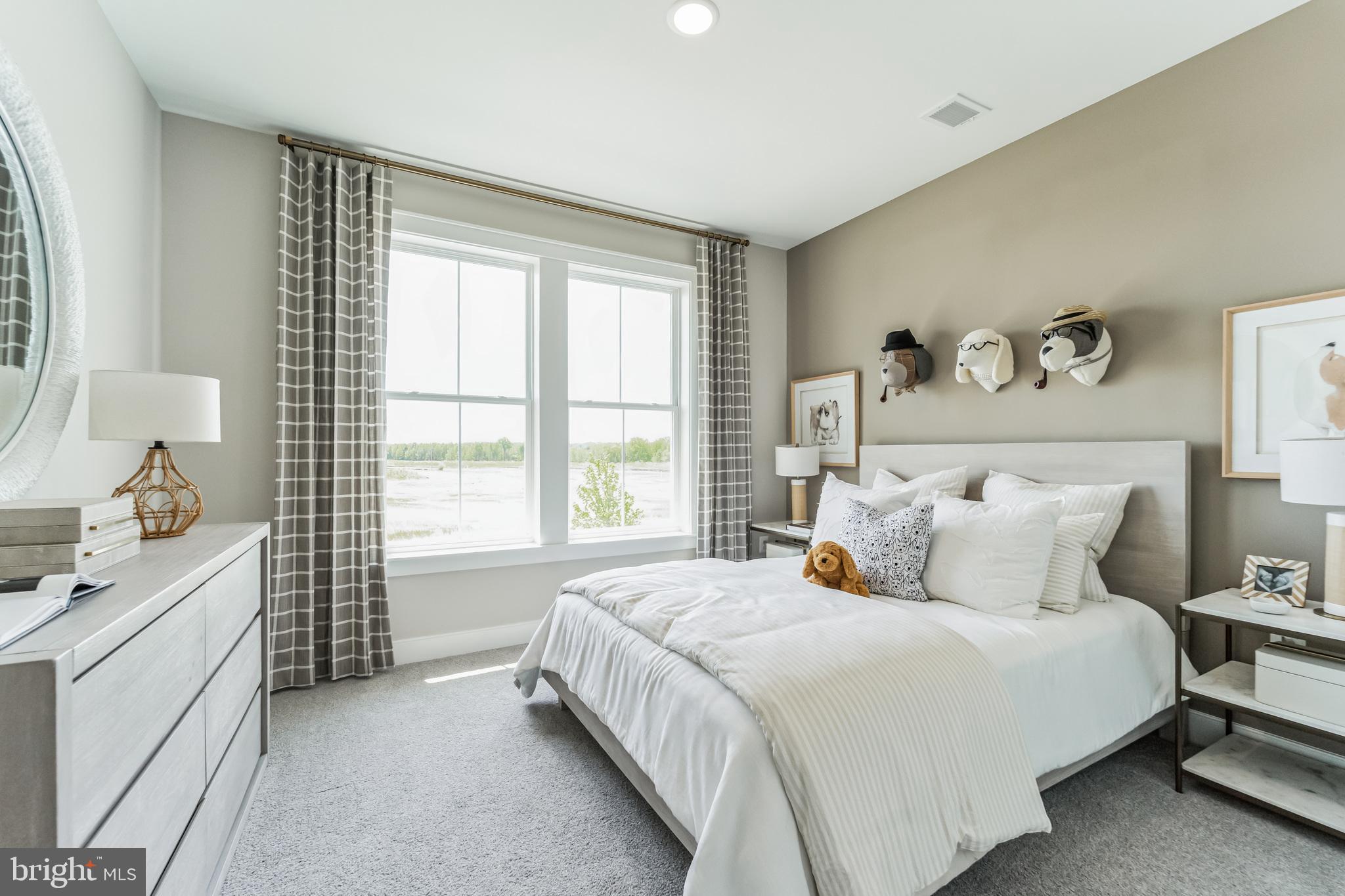 111 Flycatcher Way Stevensville, MD 21666 - Photo 19 of 48 a bedroom with a bed and a window