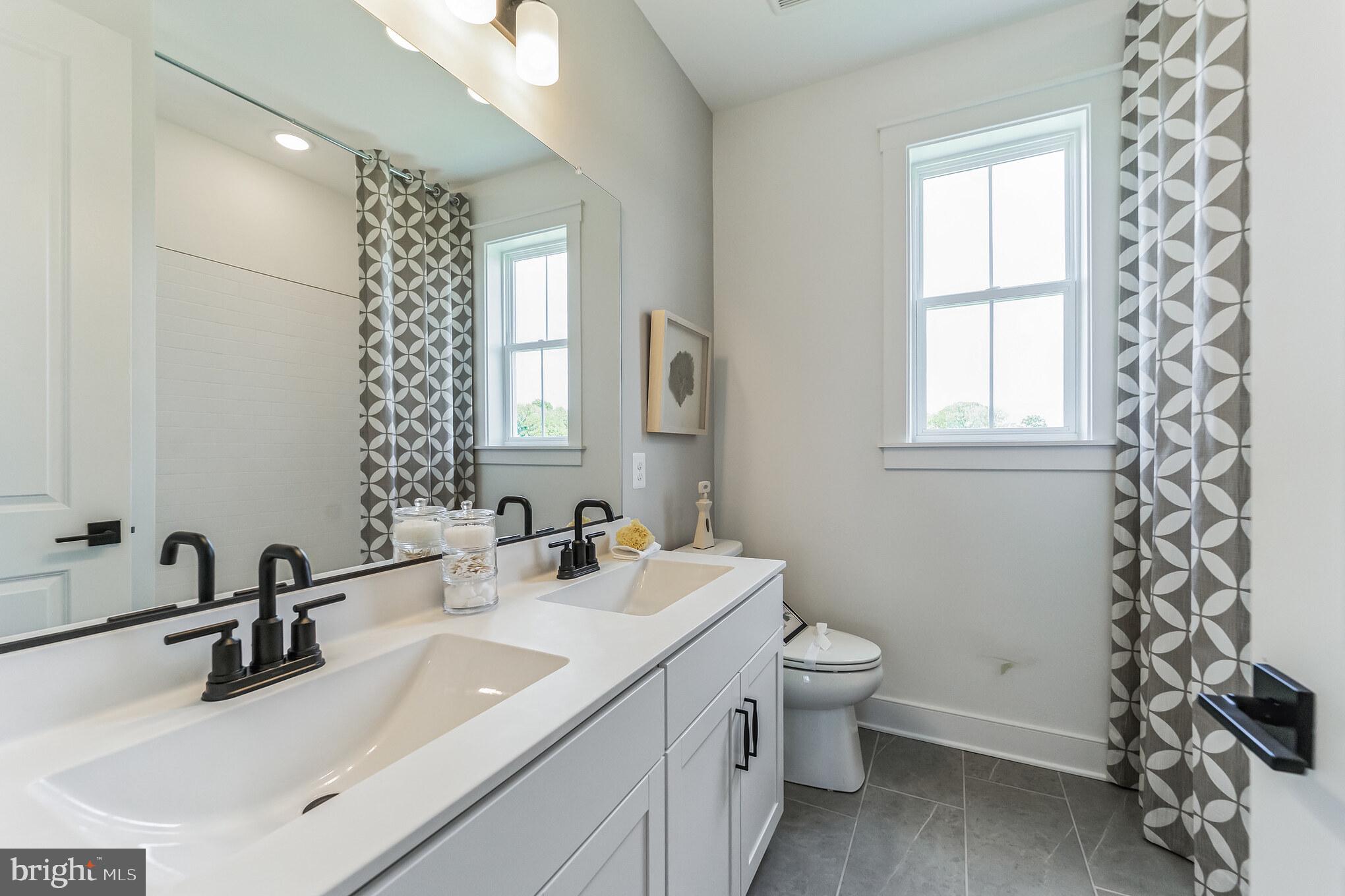 111 Flycatcher Way Stevensville, MD 21666 - Photo 20 of 48 a bathroom with a sink toilet and mirror