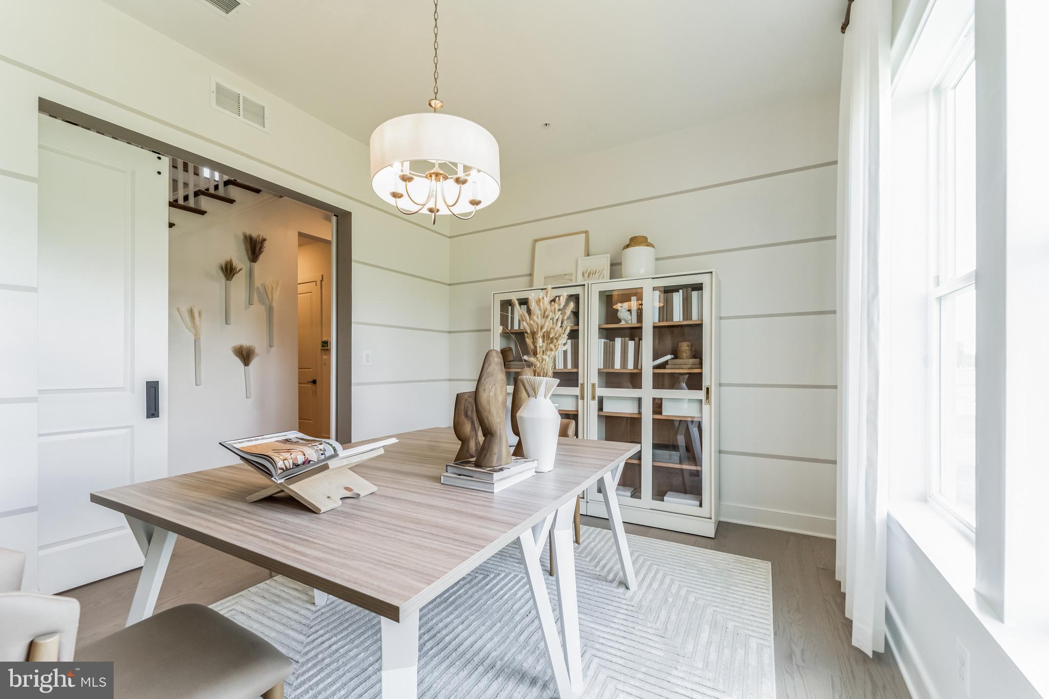 111 Flycatcher Way Stevensville, MD 21666 - Photo 2 of 48 a view of a dining room with furniture a chandelier and wooden floor