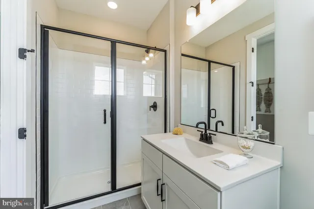 a bathroom with a sink vanity and a mirror