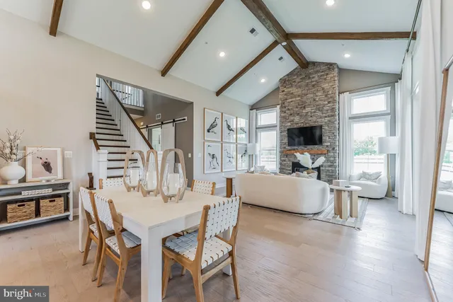 a dining room with furniture and wooden floor