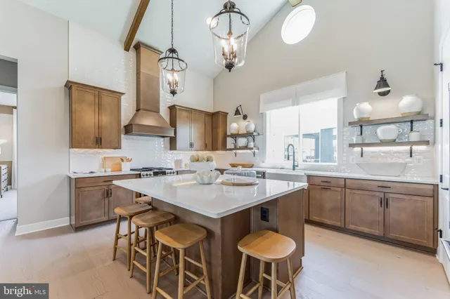 a kitchen with a dining table chairs sink and cabinets
