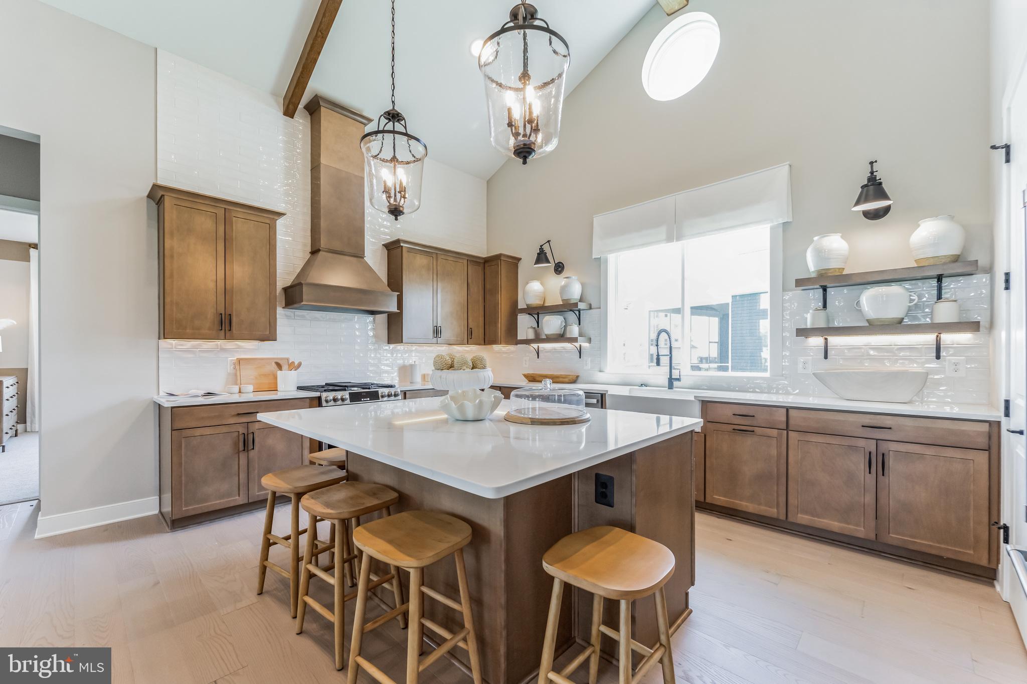 111 Flycatcher Way Stevensville, MD 21666 - Photo 5 of 48 a kitchen with a dining table chairs sink and cabinets