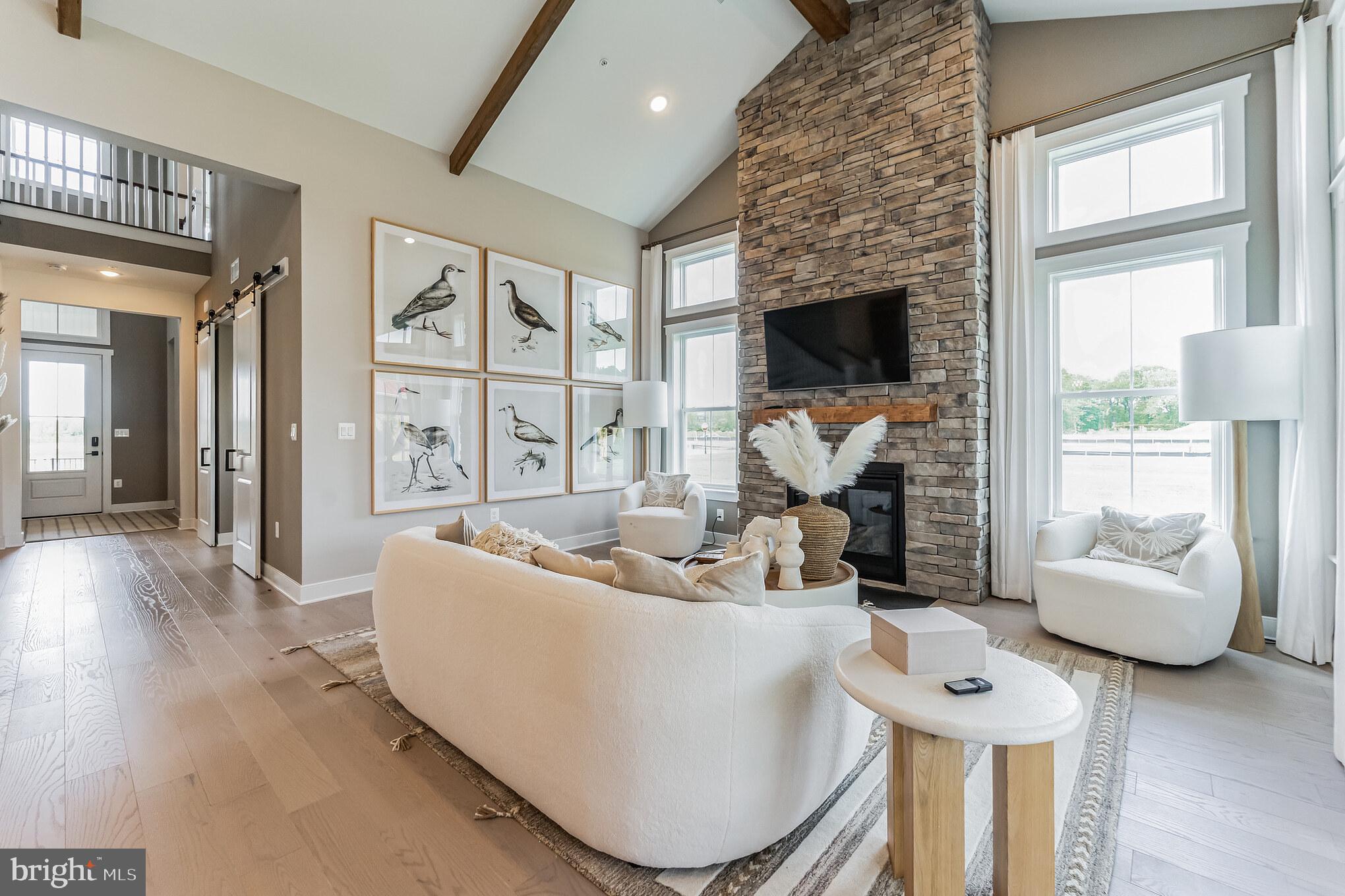 111 Flycatcher Way Stevensville, MD 21666 - Photo 6 of 48 a living room with furniture and a fireplace