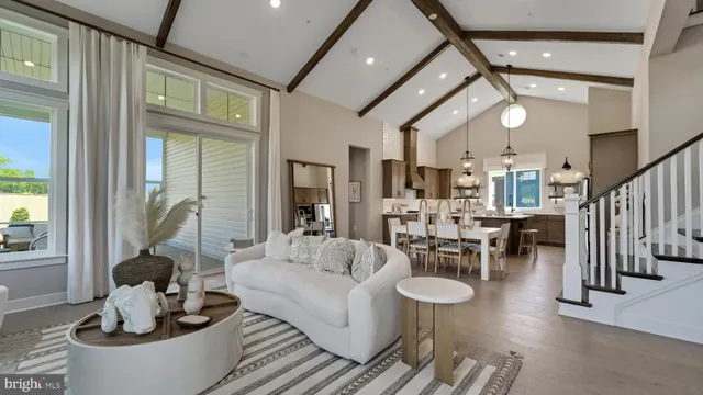 a living room with fireplace furniture and a large window