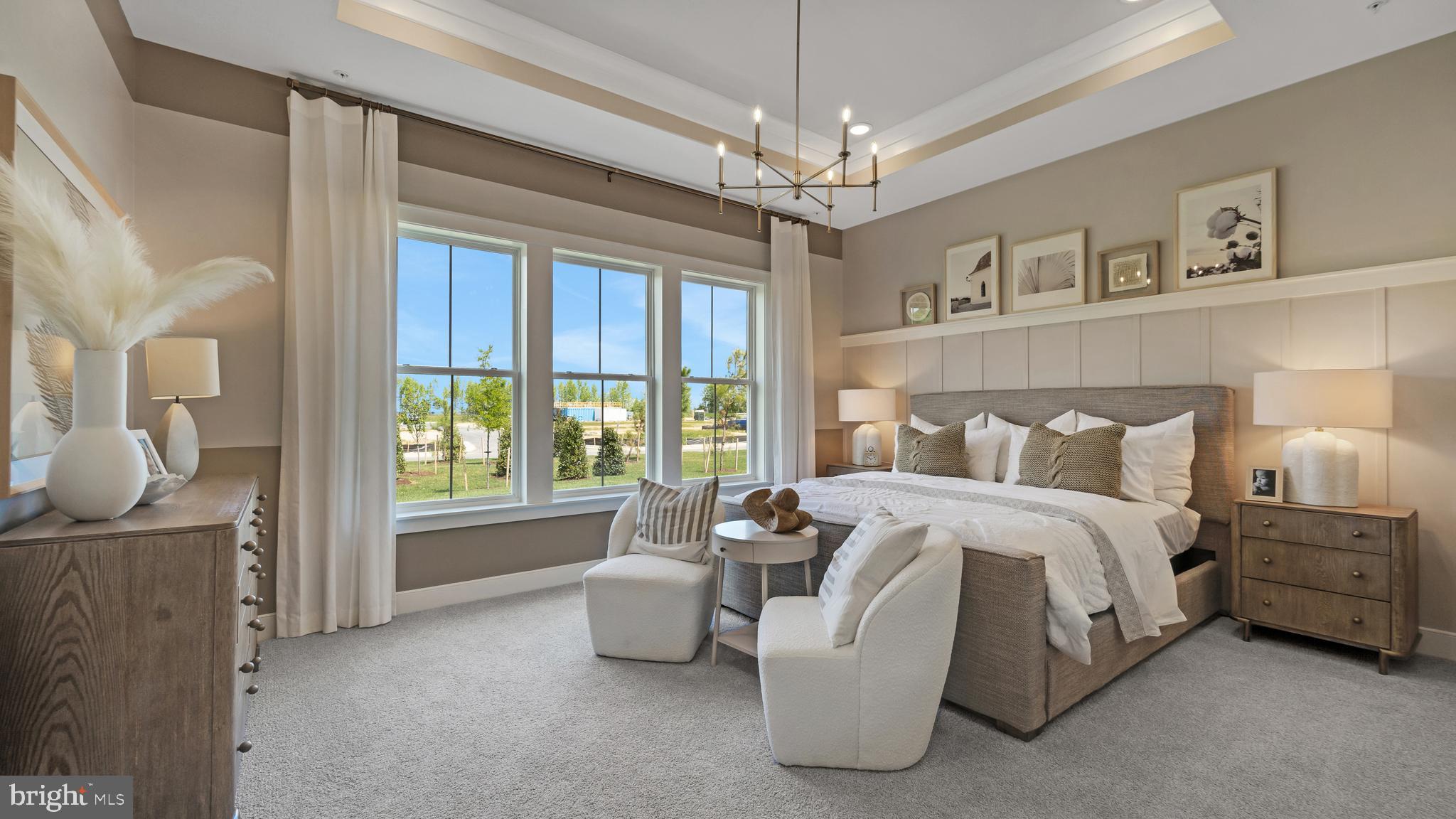 111 Flycatcher Way Stevensville, MD 21666 - Photo 9 of 48 a spacious bedroom with a bed and a chandelier