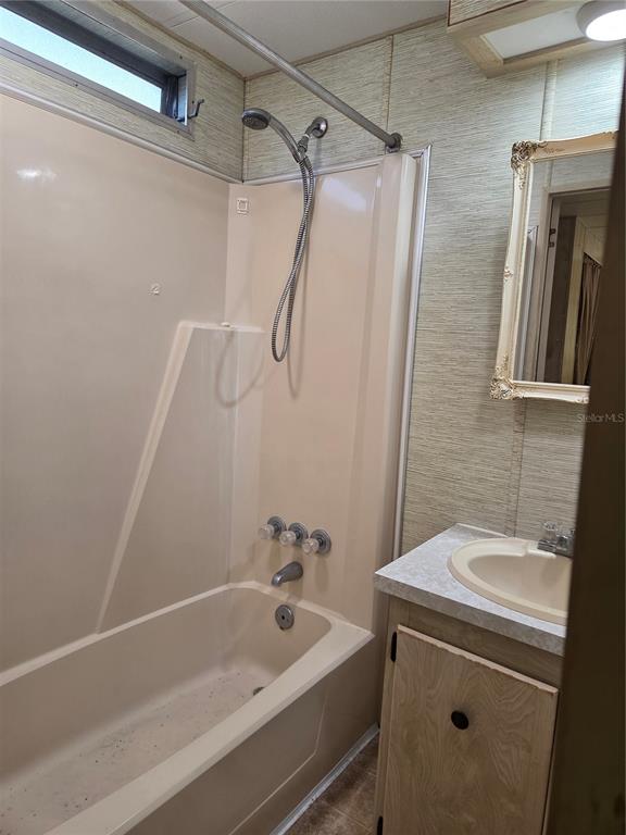 8828 Kanawha Road Riverview, FL 33578 - Photo 6 of 13 a bathroom with a sink a mirror and a bathtub