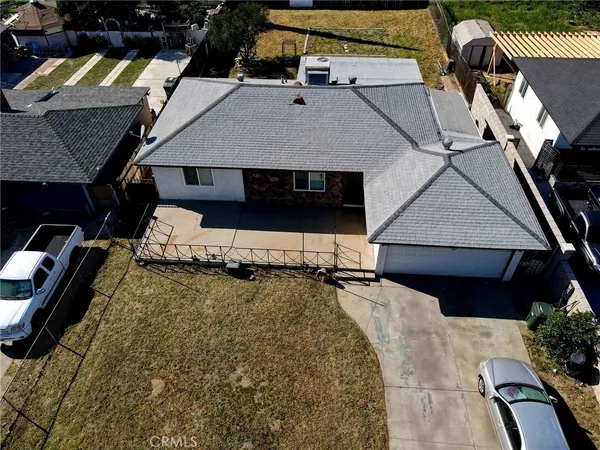 an aerial view of a house with a yard and balcony