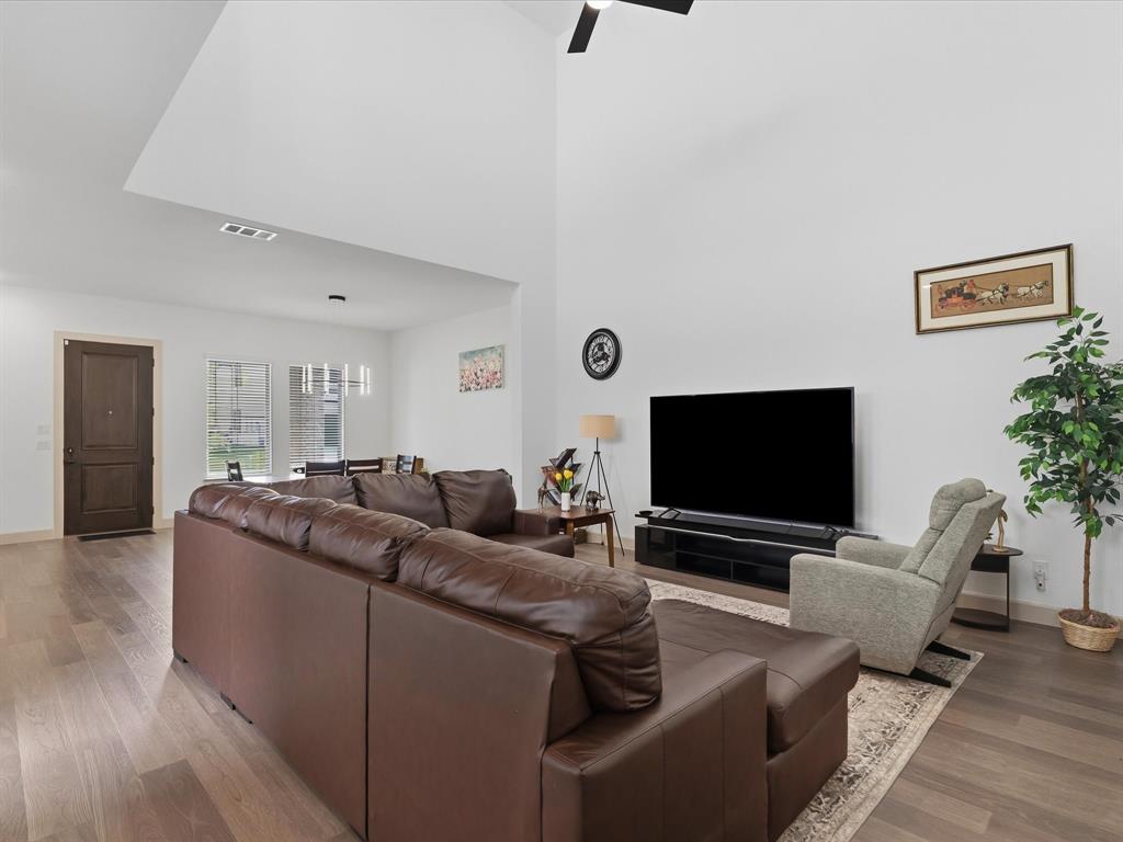 9533 Keep Street Frisco, TX 75035 - Photo 14 of 40 Spacious living area featuring high vaulted ceilings, wood-finish flooring, and a ceiling fan