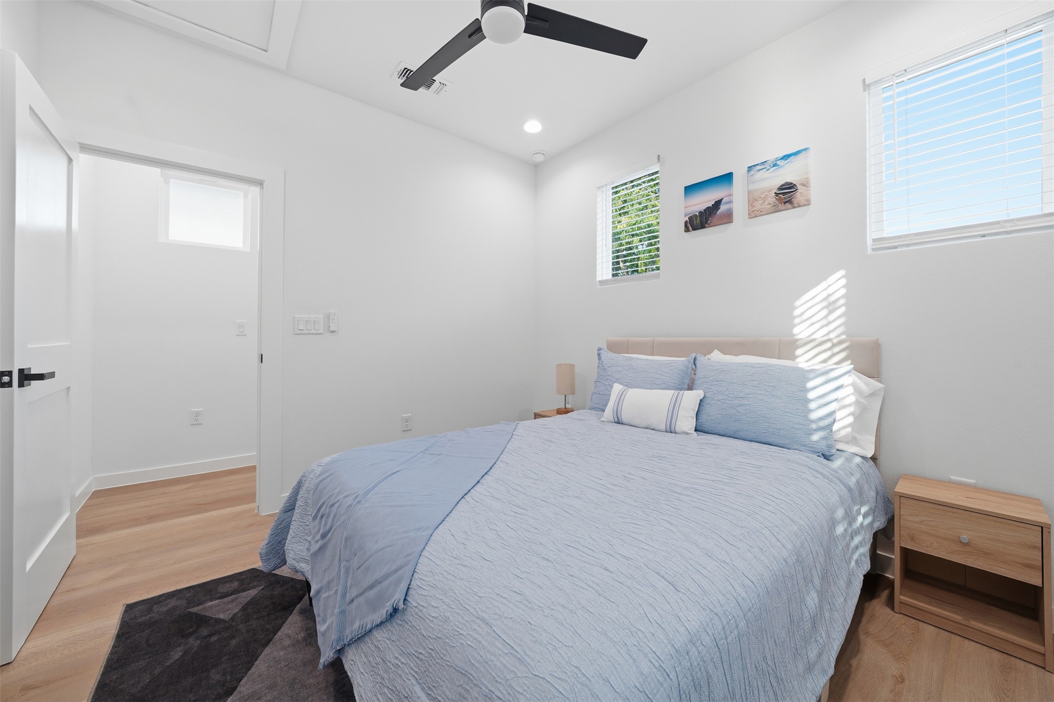 2216 Yellow Jacket Lane, Unit 2 Austin, TX 78741 - Photo 15 of 25 a bedroom with a bed ceiling fan and a window