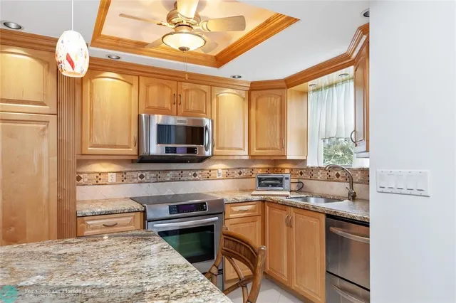 a kitchen with a stove a sink and a microwave