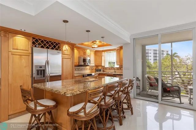 a dining room with furniture and large windows