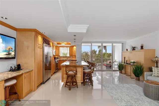 a very nice looking living room with a large window and a dining table