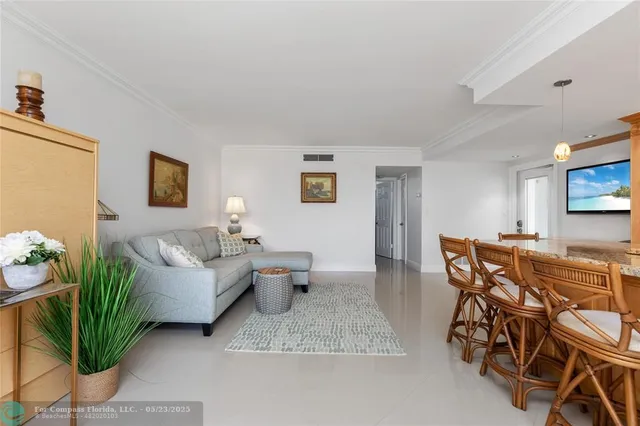 a living room with furniture a couch and a flat screen tv