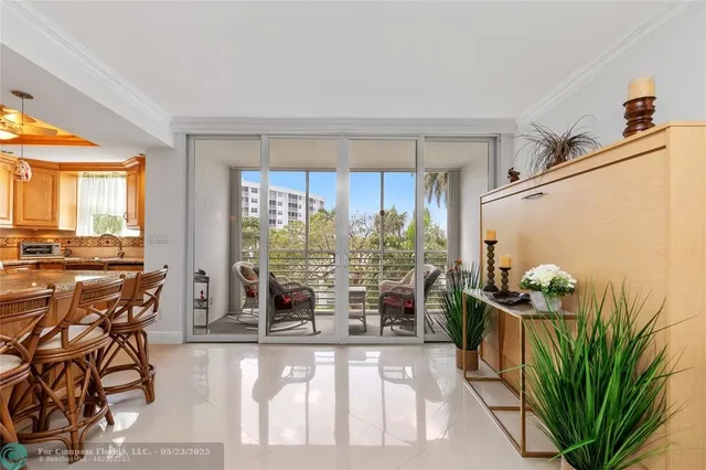 a living room filled with furniture and a potted plant
