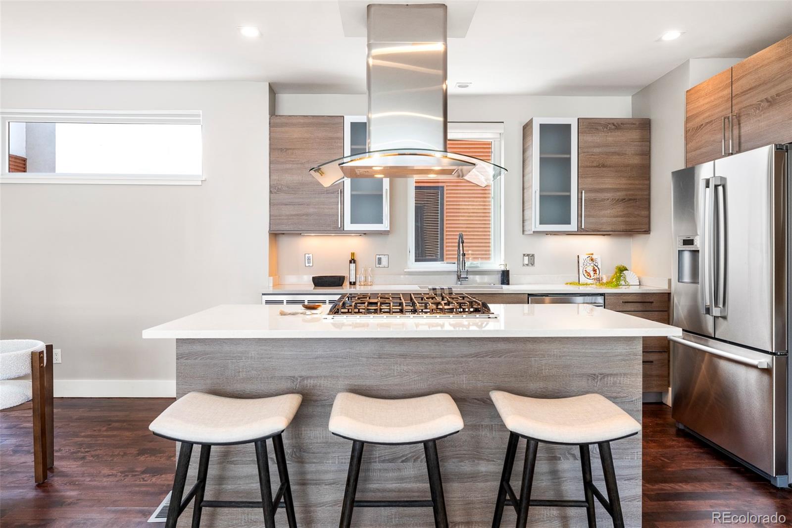 3619 Navajo Street Denver, CO 80211 - Photo 2 of 24 a kitchen with a dining table chairs and refrigerator