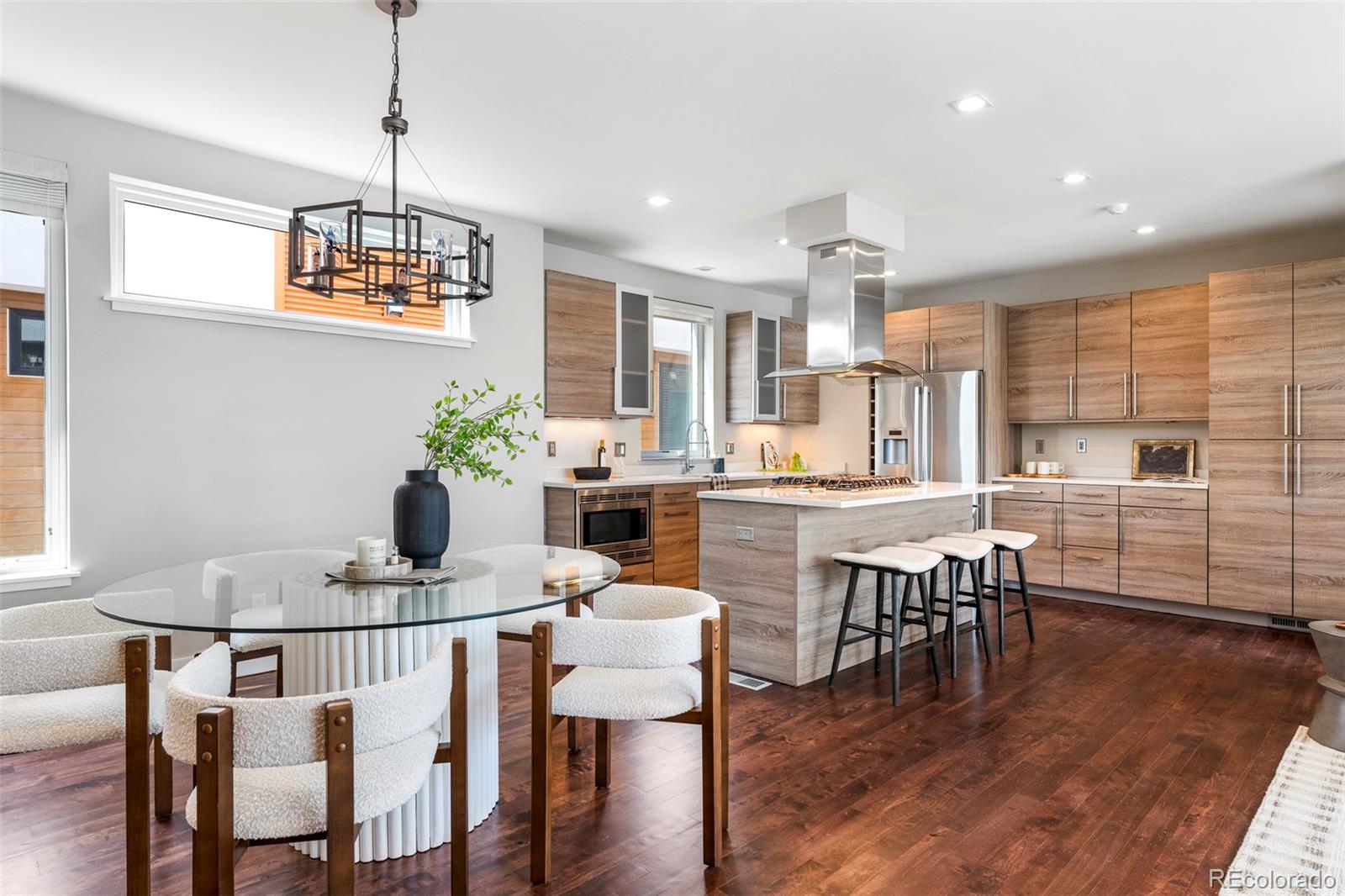 3619 Navajo Street Denver, CO 80211 - Photo 3 of 24 a dining room with furniture a chandelier and wooden floor