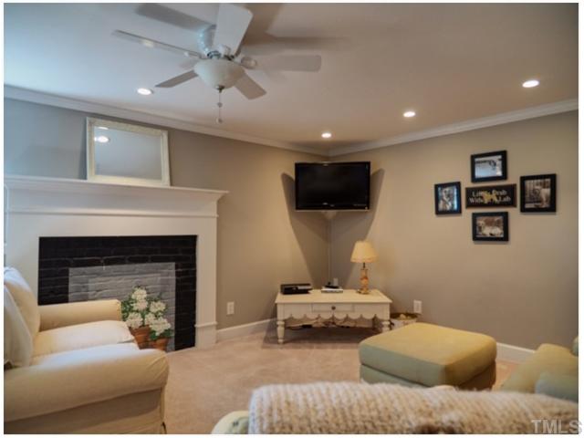 608 Yale Street Raleigh, NC 27609 - Photo 8 of 10 a bedroom with furniture and a fireplace