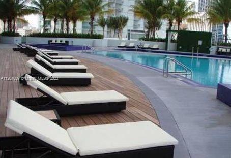 90 Southwest 3rd Street, Unit 3012 Miami, FL 33130 - Photo 14 of 16 a view of swimming pool with lounge chair and palm trees
