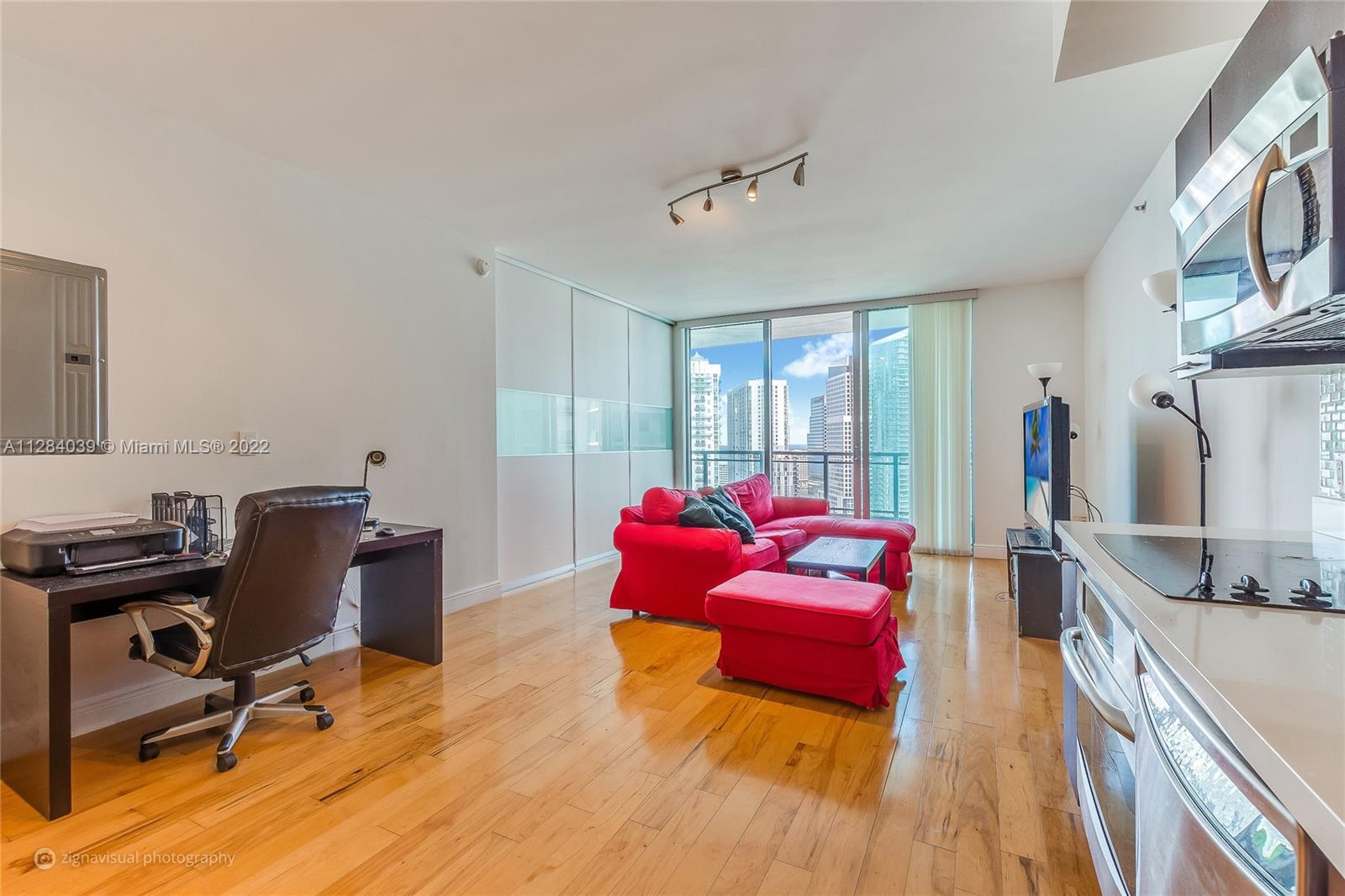 90 Southwest 3rd Street, Unit 3012 Miami, FL 33130 - Photo 5 of 16 a livingroom with workspace and a couch