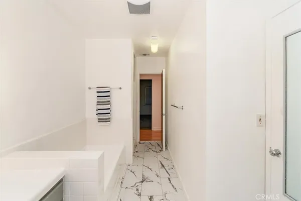 a view of a room with wooden floor