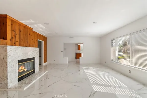 a view of empty room with a fireplace