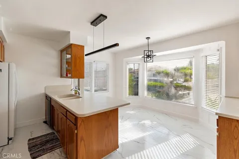 a bathroom with sink shower and mirror