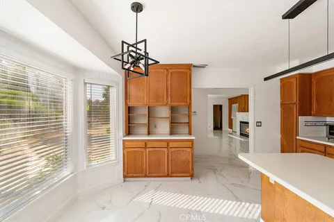 a view of an empty room with a window and fireplace