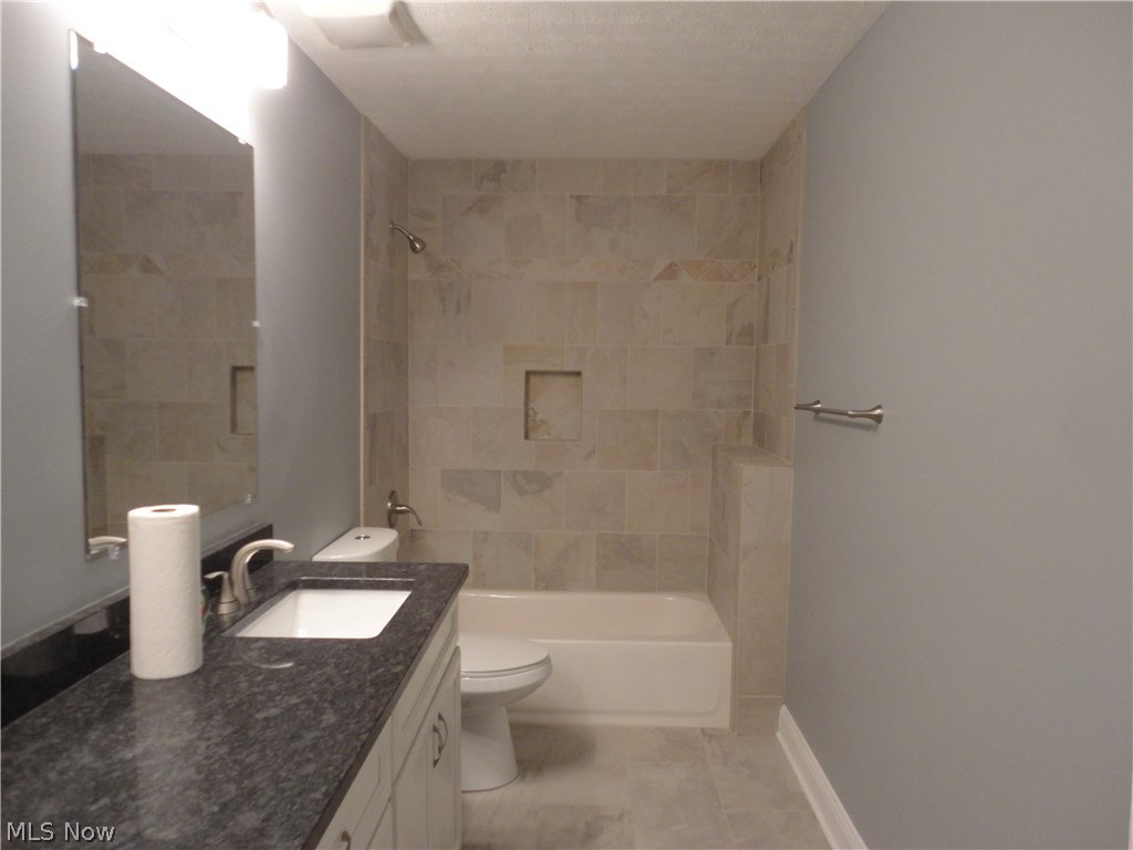 19646 Prospect Road Strongsville, OH 44149 - Photo 24 of 32 Main bath with dual sinks, tiled tub/shower all located on bedroom wing of house.