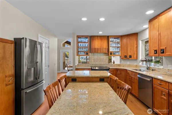a large kitchen with a large window and stainless steel appliances