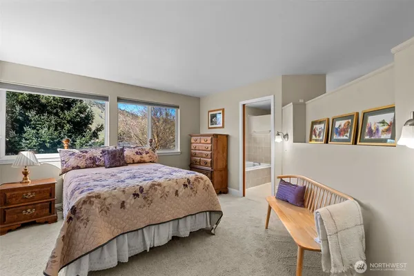 a bedroom with a bed wooden floor and window