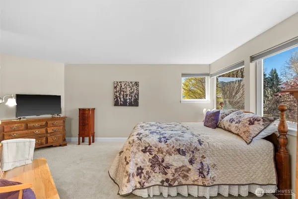 a bedroom with a bed and a couch