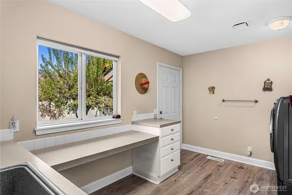 a living room with a window and a wooden floor