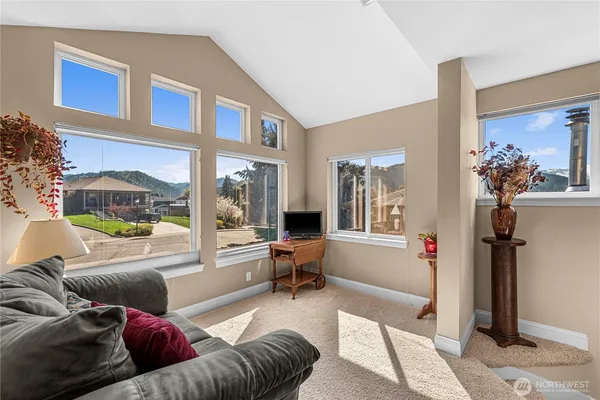 a living room with furniture and a floor to ceiling window