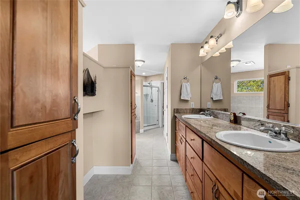 a bathroom with a granite countertop sink shower and a mirror