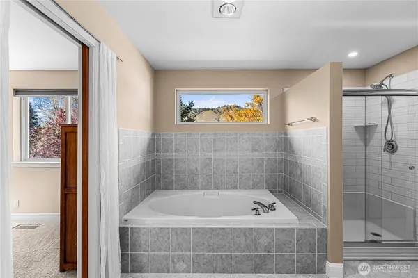 a bath tub sitting next to a small bathroom
