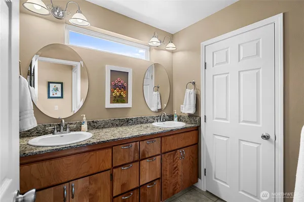 a bathroom with a double vanity sink and a mirror