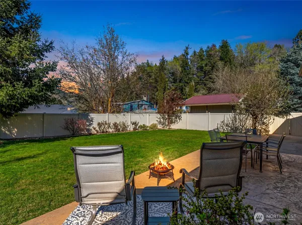 a view of a chair and table on the garden