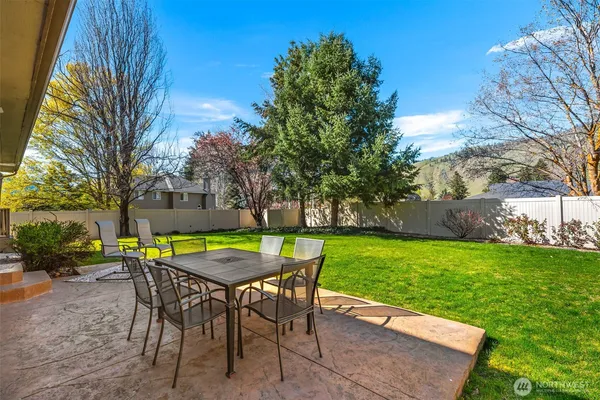 a view of a backyard with a table and chairs