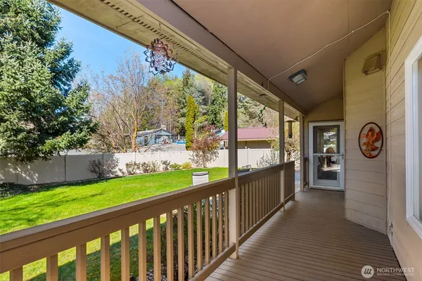 a view of a porch with wooden floor and fence