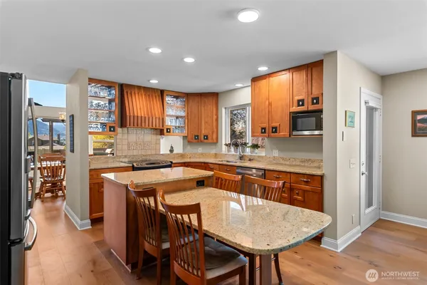 a kitchen with a table chairs sink and cabinets